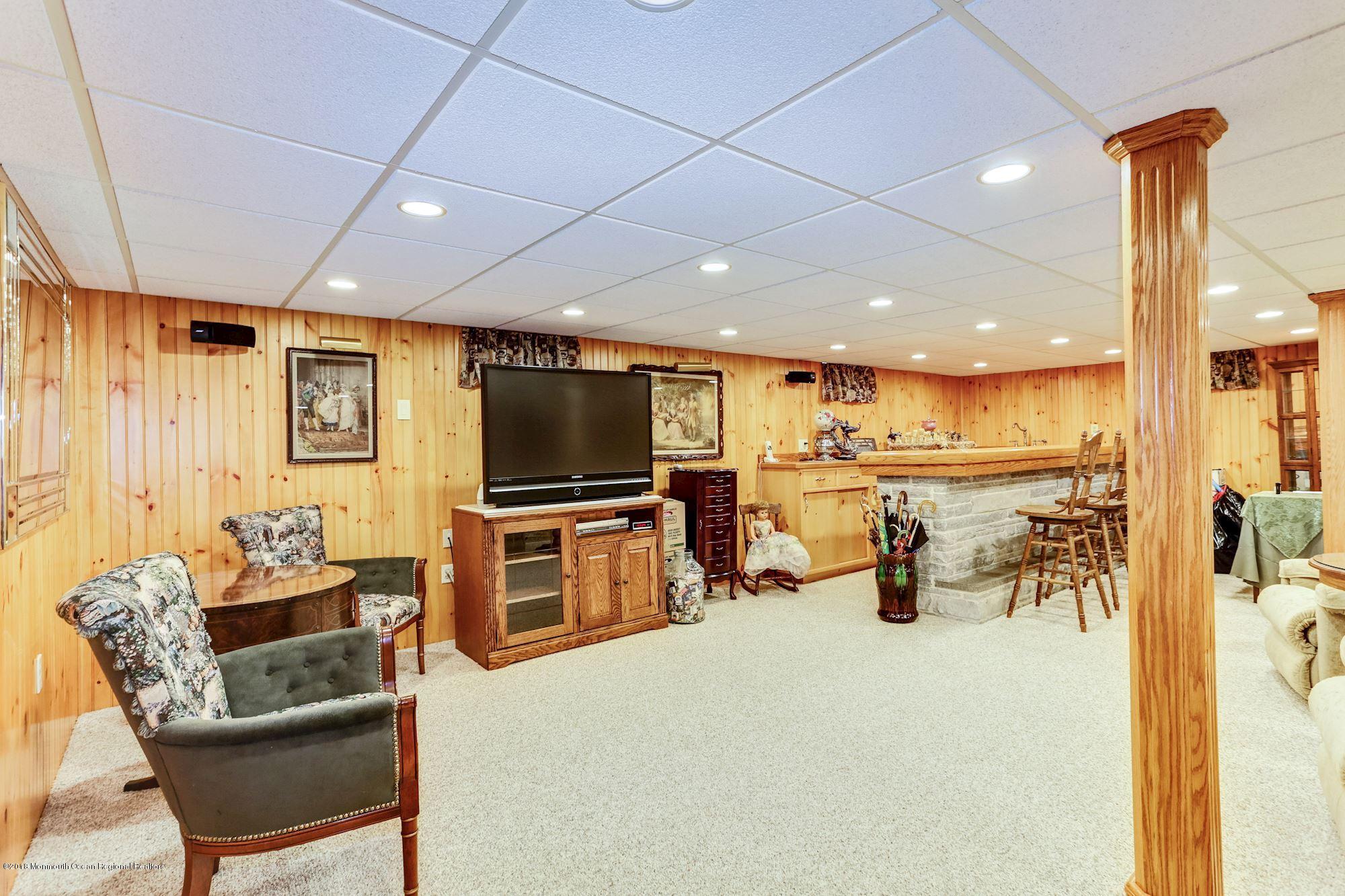 9 Kenmore Road Freehold, NJ 07728 - Photo 22 of 25 a living room with furniture and a flat screen tv