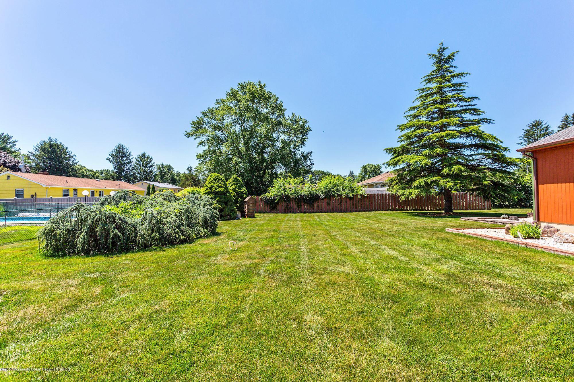 9 Kenmore Road Freehold, NJ 07728 - Photo 23 of 25 a view of yard with swimming pool and green space