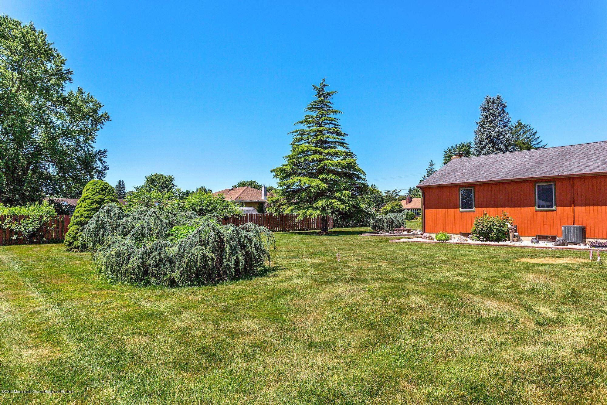 9 Kenmore Road Freehold, NJ 07728 - Photo 24 of 25 a front view of a house with a yard