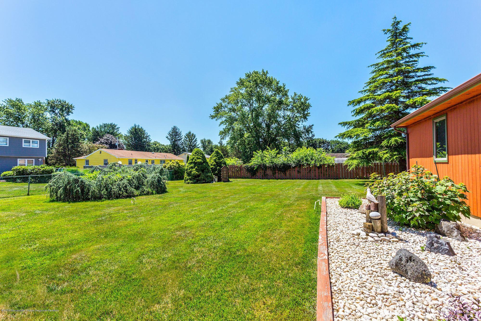 9 Kenmore Road Freehold, NJ 07728 - Photo 25 of 25 a view of a garden with a building in the background