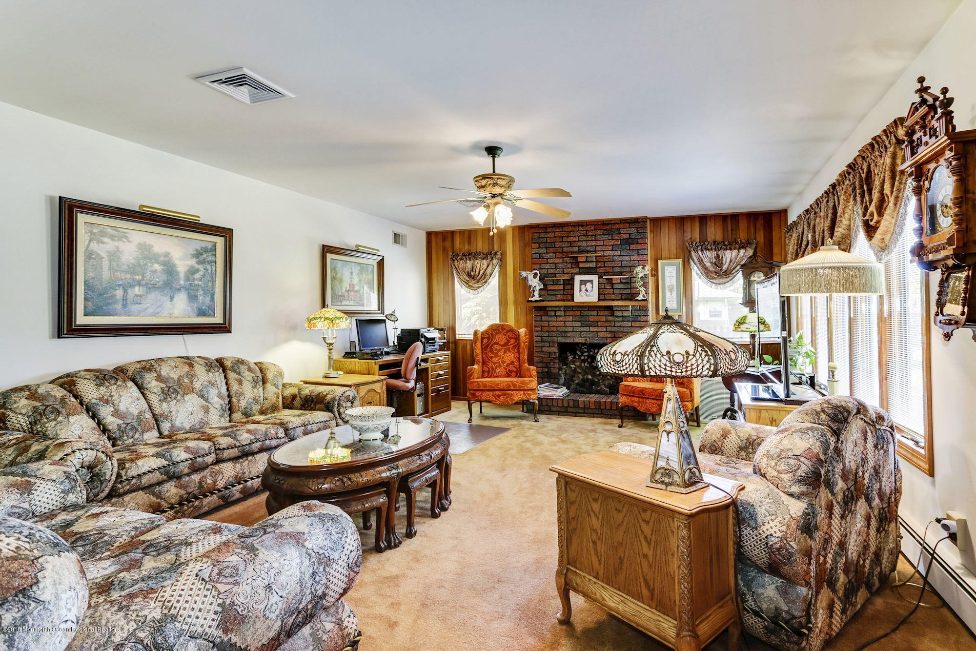 9 Kenmore Road Freehold, NJ 07728 - Photo 5 of 25 a living room with furniture large window and flat screen tv