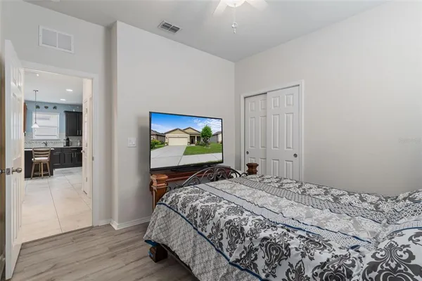 a bedroom with a bed and a chandelier