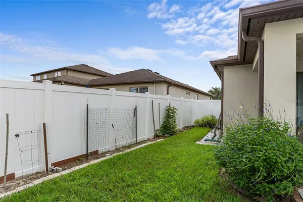 a view of a house with a yard and pathway