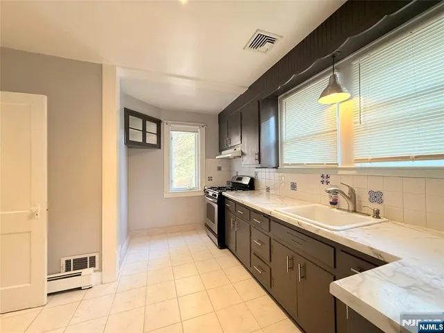a view of a kitchen with a sink and a window