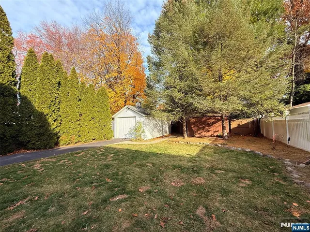 a backyard of a house with large trees