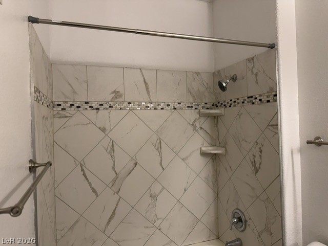 3318 North Decatur Boulevard, Unit 1163 Las Vegas, NV 89130 - Photo 27 of 35 A well-appointed shower with elegant tile work and practical shelving for comfort and utility.