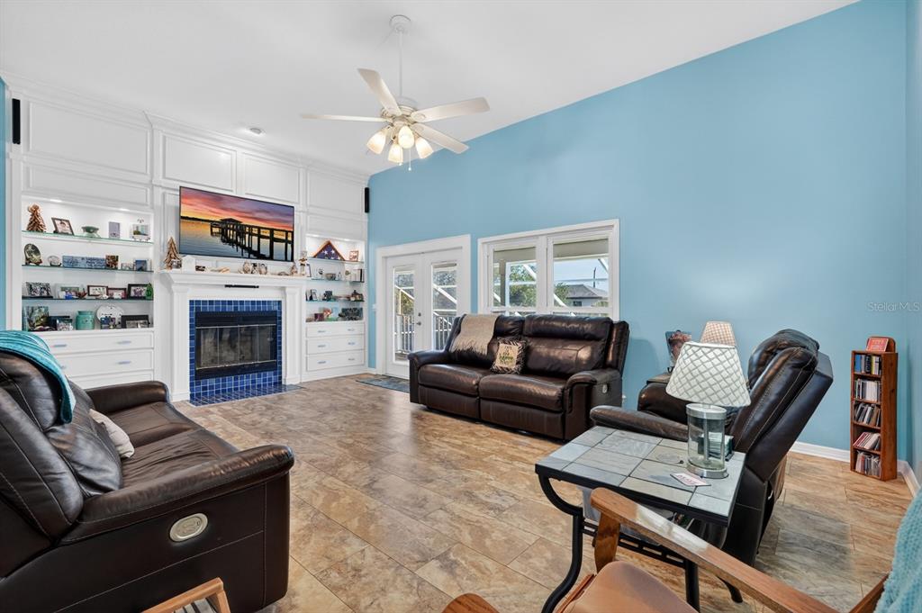 49 Loggerhead Court Ponce Inlet, FL 32127 - Photo 14 of 59 a living room with furniture a flat screen tv and a fireplace