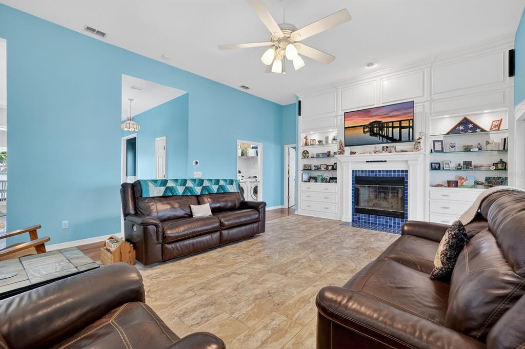 49 Loggerhead Court Ponce Inlet, FL 32127 - Photo 15 of 59 a living room with furniture a fireplace and a flat screen tv
