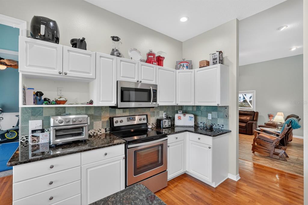 49 Loggerhead Court Ponce Inlet, FL 32127 - Photo 20 of 59 a kitchen with white cabinets and appliances
