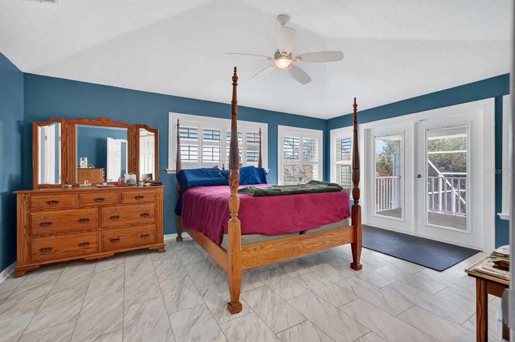 49 Loggerhead Court Ponce Inlet, FL 32127 - Photo 25 of 59 a spacious bedroom with a bed and a dresser