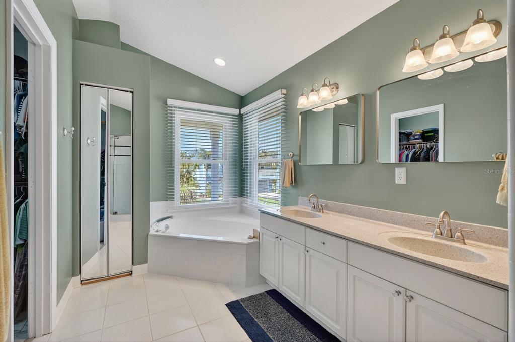 49 Loggerhead Court Ponce Inlet, FL 32127 - Photo 28 of 59 a bathroom with a tub a sink and mirror