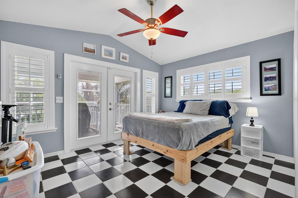 49 Loggerhead Court Ponce Inlet, FL 32127 - Photo 31 of 59 a living room with a black white checkered floor with a gaming machine and dining table