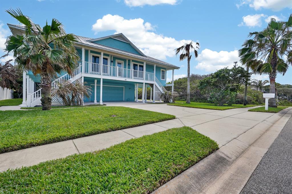 49 Loggerhead Court Ponce Inlet, FL 32127 - Photo 57 of 59 a front view of a house with a yard and potted plants