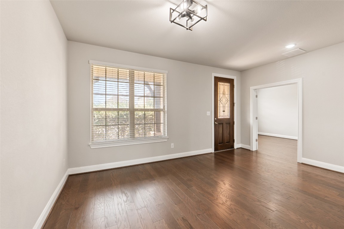 2260 Hat Bender Loop Round Rock, TX 78664 - Photo 11 of 40 an empty room with wooden floor and windows