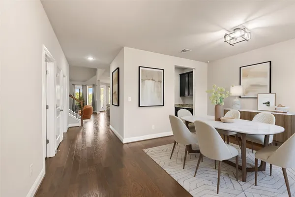 a view of a a dining room with furniture window and wooden floor
