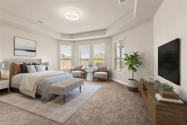 a spacious bedroom with a bed and a flat screen television