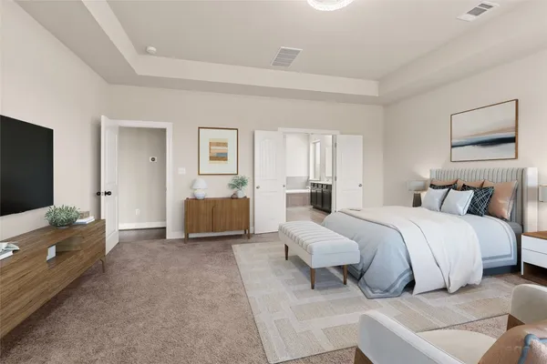 a spacious bedroom with a bed and a couch