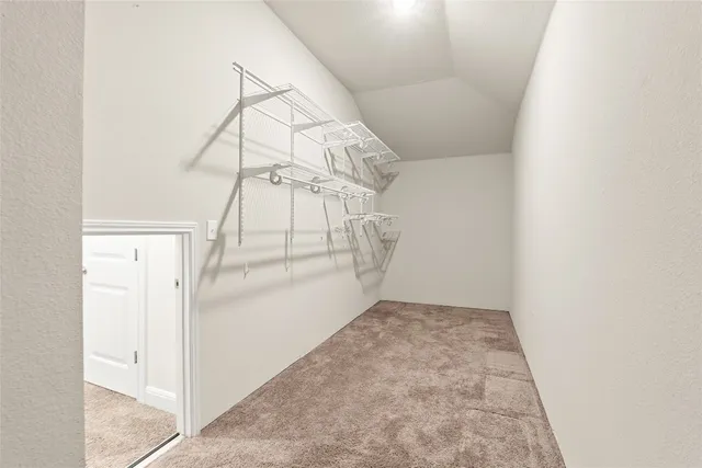 an empty room with white walls and stairs
