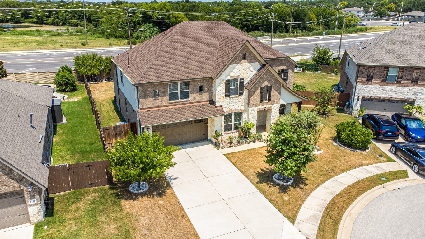 2260 Hat Bender Loop Round Rock, TX 78664 - Photo 3 of 40 an aerial view of a house with a garden and lake view