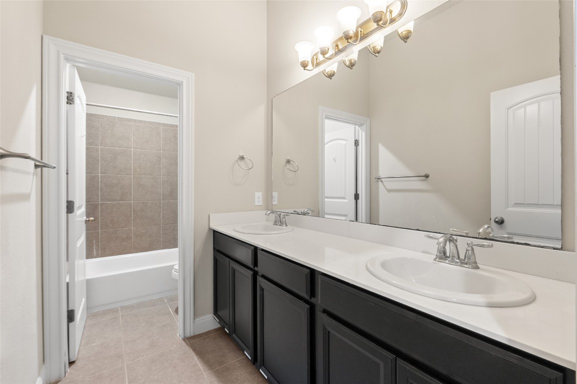 2260 Hat Bender Loop Round Rock, TX 78664 - Photo 31 of 40 a bathroom with a sink double vanity granite tub and a mirror