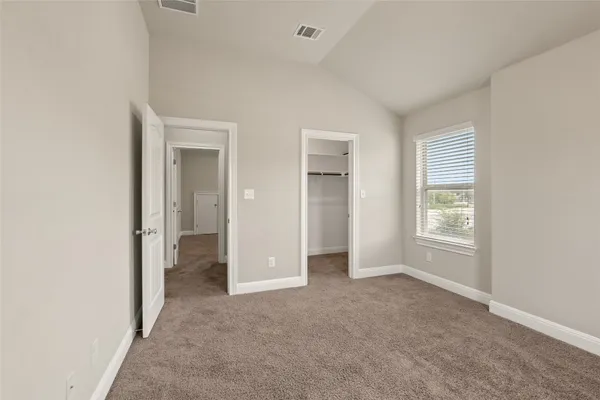 an empty room with windows and closet