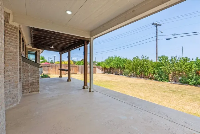 a view of an empty room and floor to ceiling window