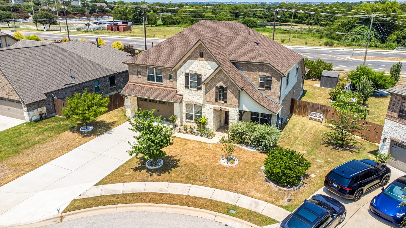2260 Hat Bender Loop Round Rock, TX 78664 - Photo 4 of 40 an aerial view of a house with a swimming pool patio and lake view