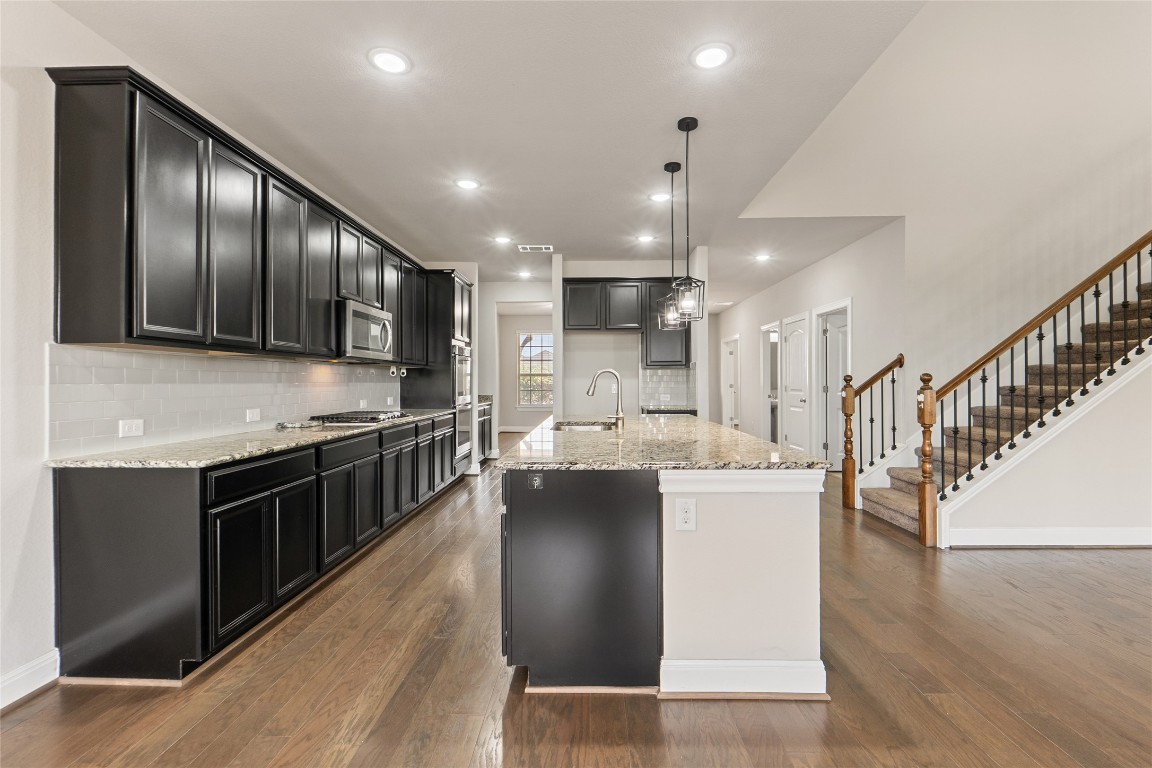 2260 Hat Bender Loop Round Rock, TX 78664 - Photo 5 of 40 a kitchen with kitchen island granite countertop lots of counter top space a sink and appliances