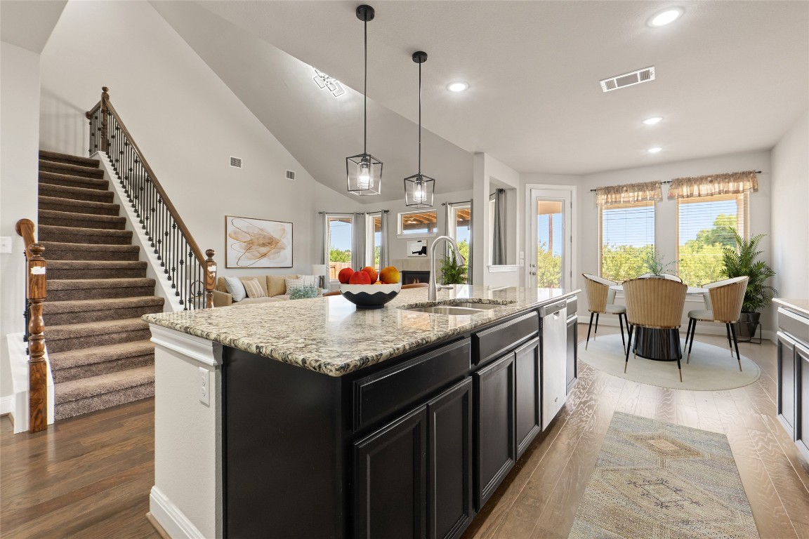 2260 Hat Bender Loop Round Rock, TX 78664 - Photo 6 of 40 a kitchen with center island and wooden floors