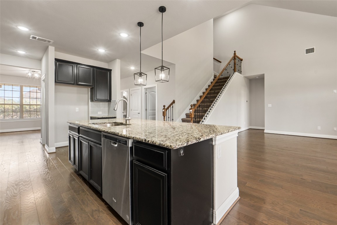 2260 Hat Bender Loop Round Rock, TX 78664 - Photo 8 of 40 a kitchen with stainless steel appliances granite countertop a sink a stove and a wooden floors