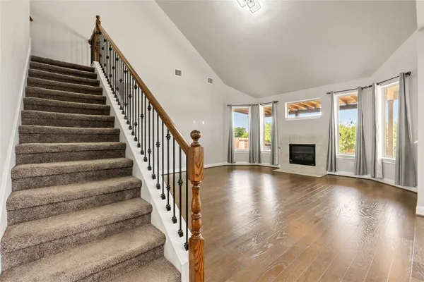 a view of entryway and hall with wooden floor