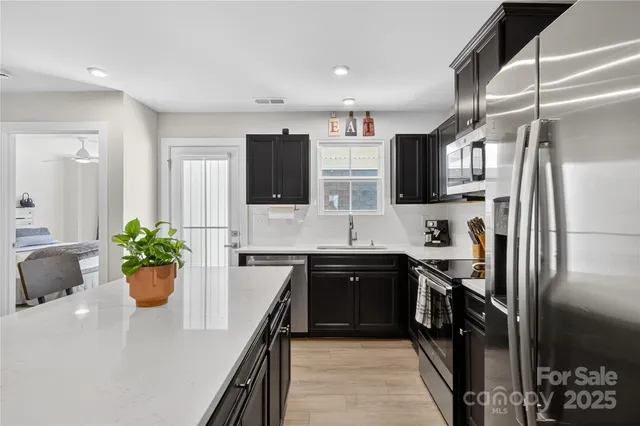a kitchen with a sink stainless steel appliances and cabinets