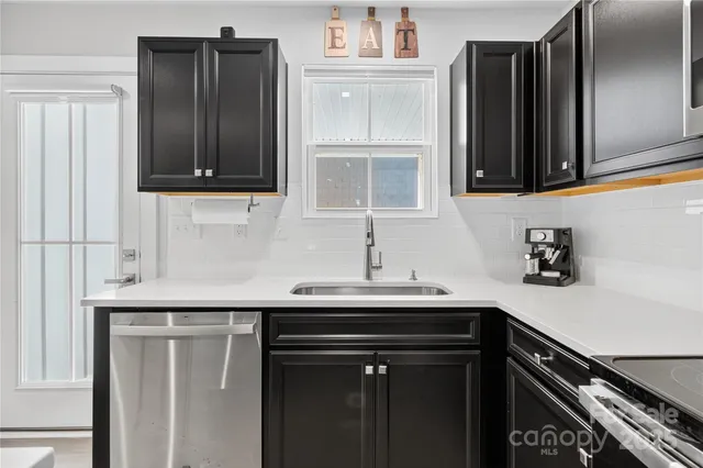 a kitchen with a sink and cabinets