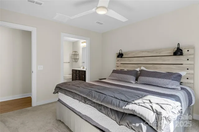 a bedroom with a bed and ceiling fan