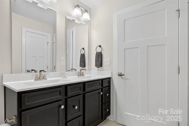 a bathroom with a double vanity sink and mirror