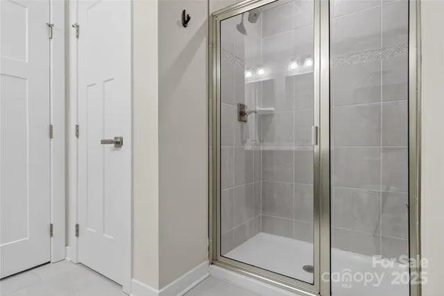 a bathroom with a glass shower door