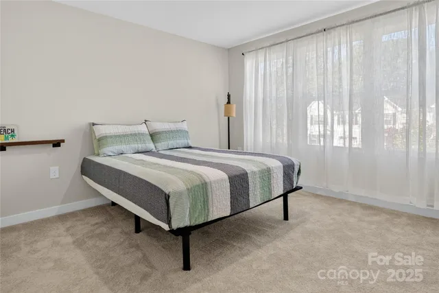 a bedroom with a bed and window