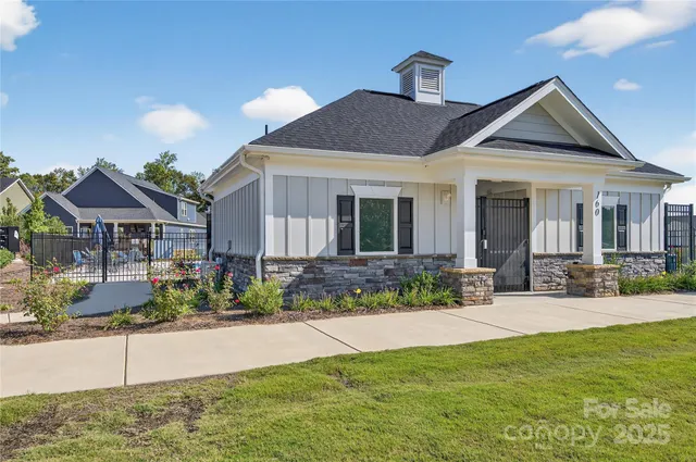 a view of house with yard and outdoor seating
