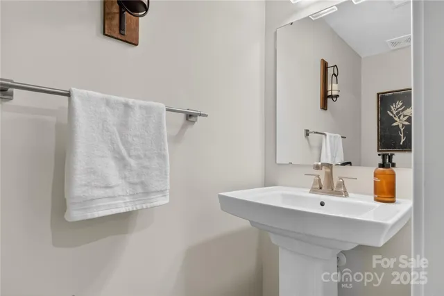a bathroom with a sink and mirror