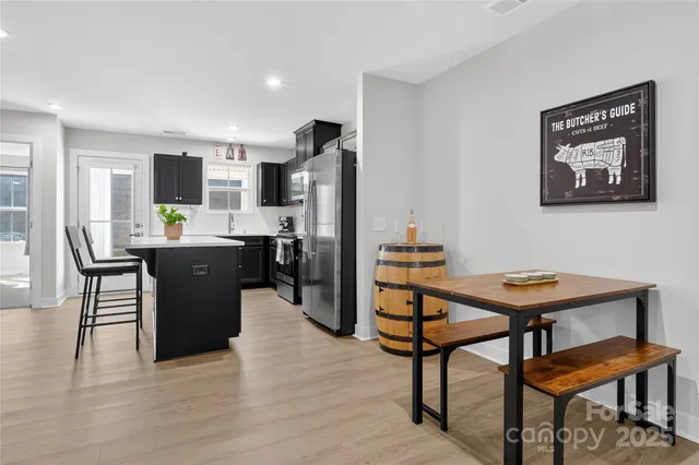 a view of a dining room with furniture and a window