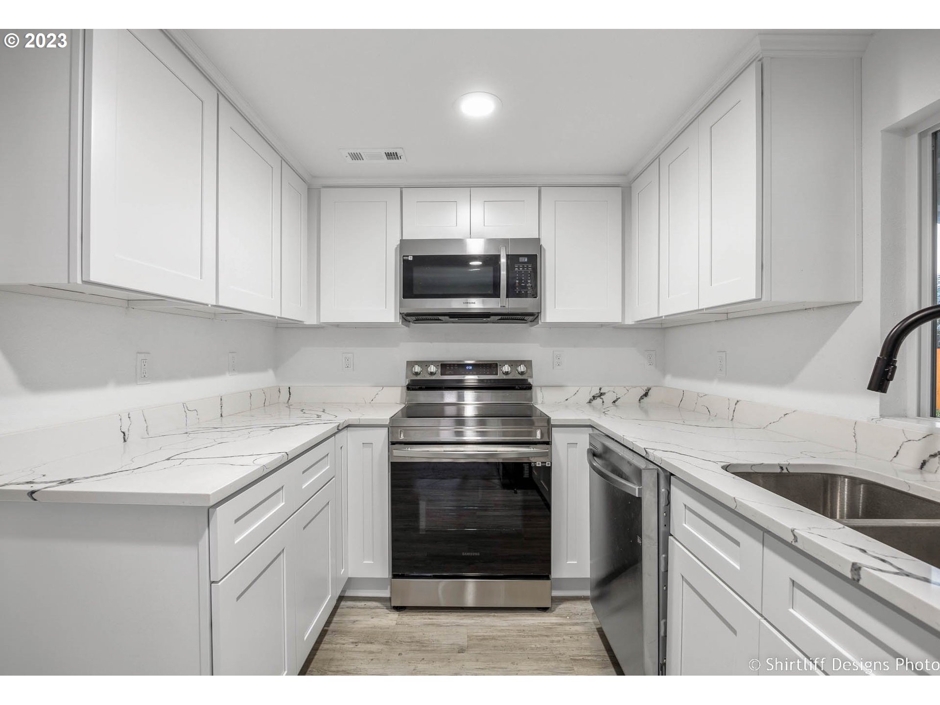 735 West M Street Springfield, OR 97477 - Photo 12 of 29 a kitchen with a sink stove and cabinets