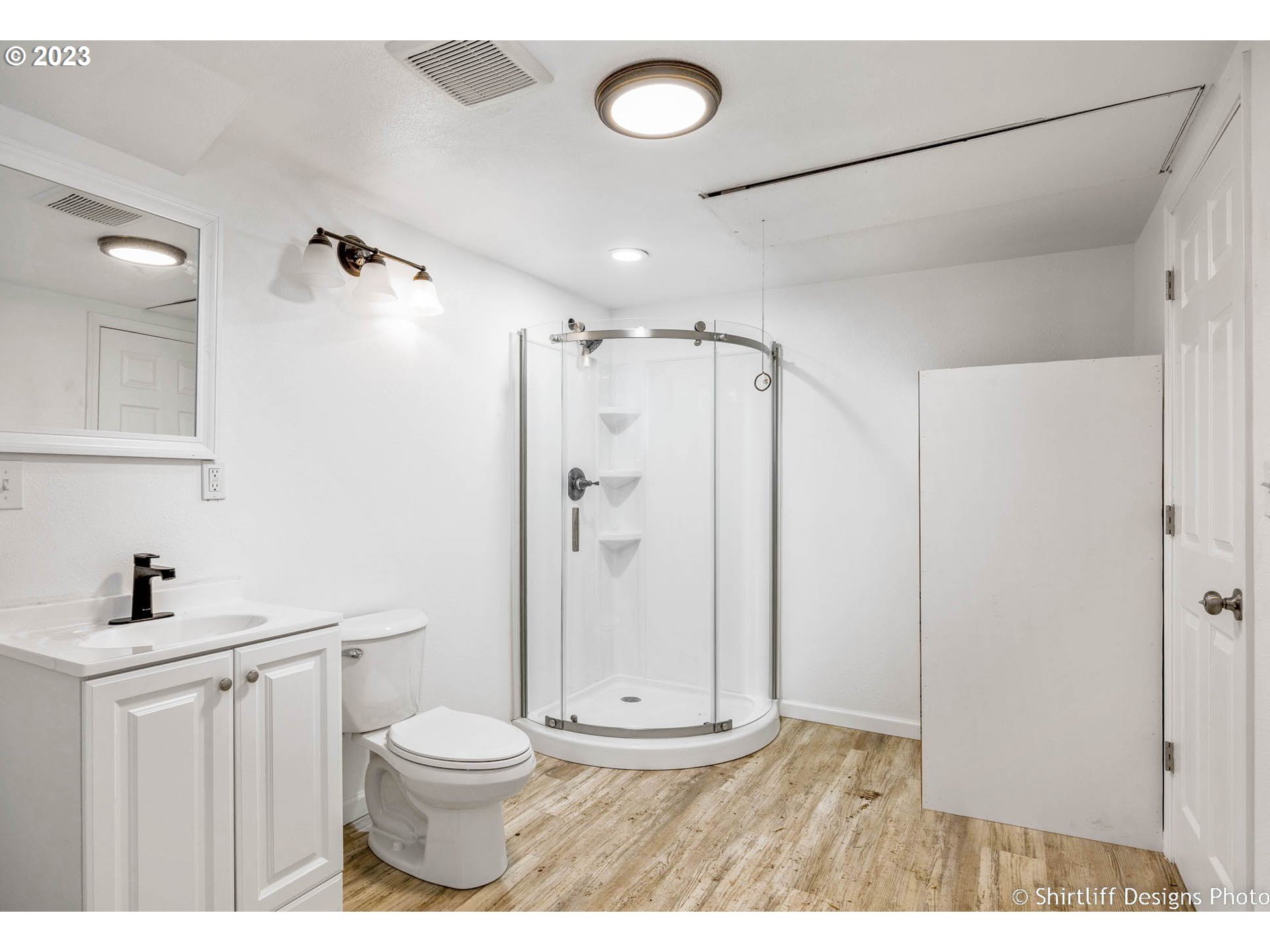 735 West M Street Springfield, OR 97477 - Photo 17 of 29 a bathroom with a granite countertop sink a toilet a mirror and shower