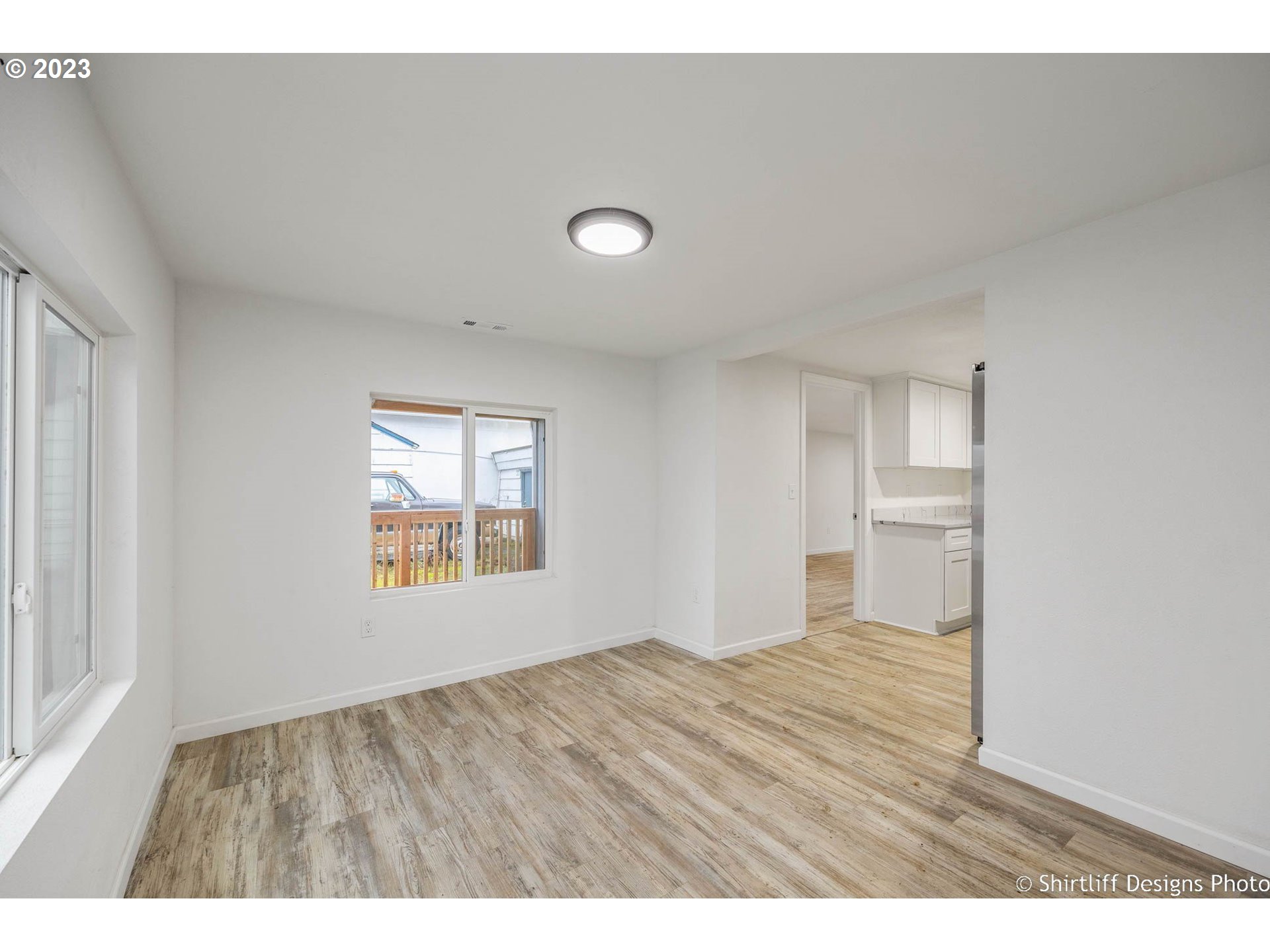 735 West M Street Springfield, OR 97477 - Photo 9 of 29 a view of an empty room with wooden floor and a window