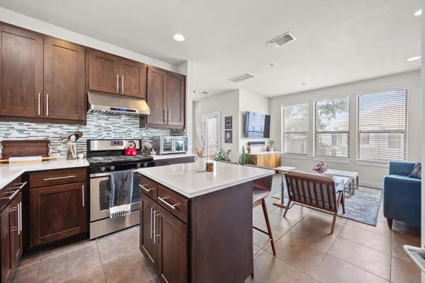 a kitchen with granite countertop wooden cabinets and stainless steel appliances