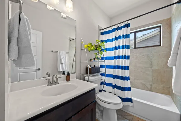 a bathroom with a shower and a toilet