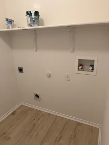 a view of a small space with shelf on the wall