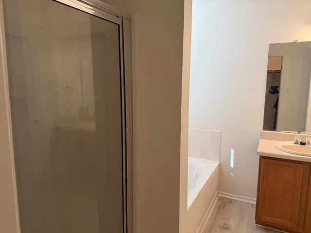 a bathroom with a shower and a sink