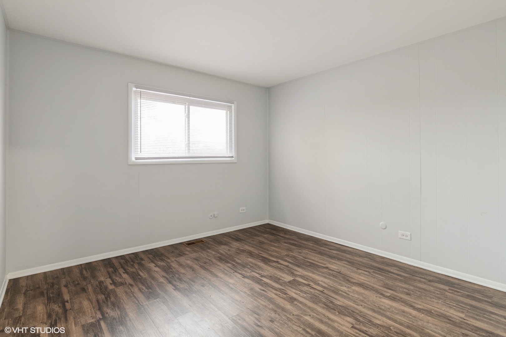 9349 Dee Road Des Plaines, IL 60016 - Photo 11 of 22 wooden floor in an empty room with a window