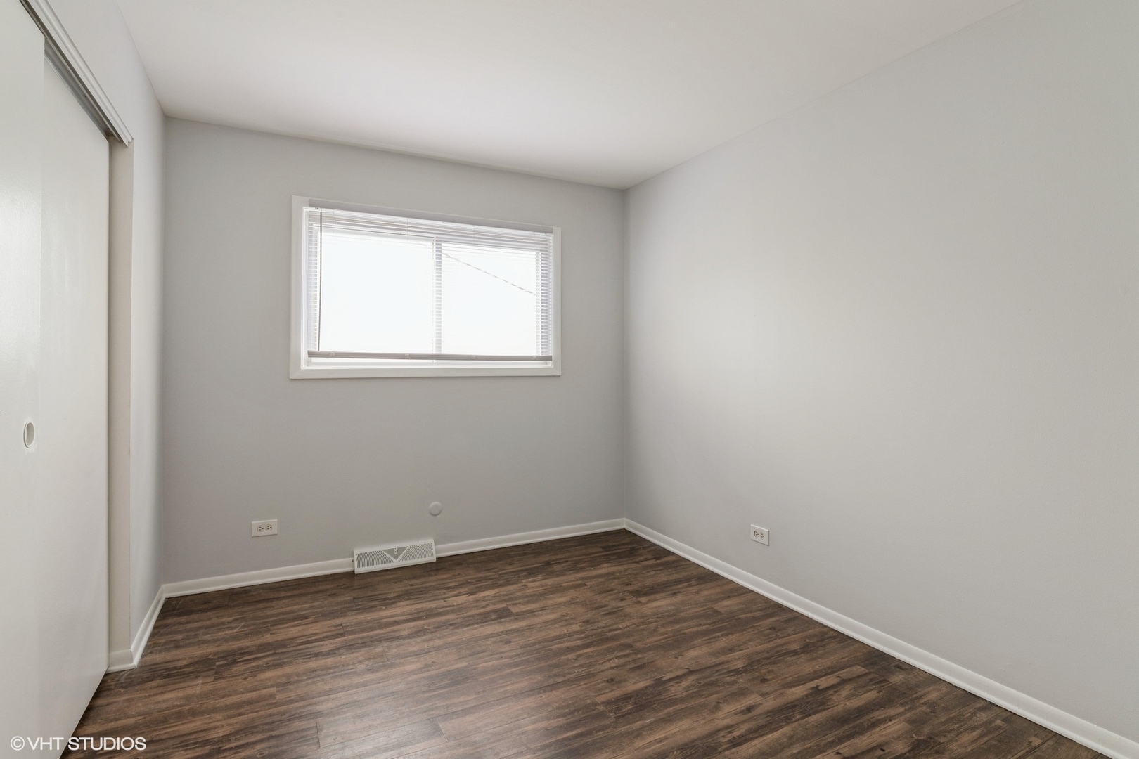 9349 Dee Road Des Plaines, IL 60016 - Photo 13 of 22 an empty room with wooden floor and windows