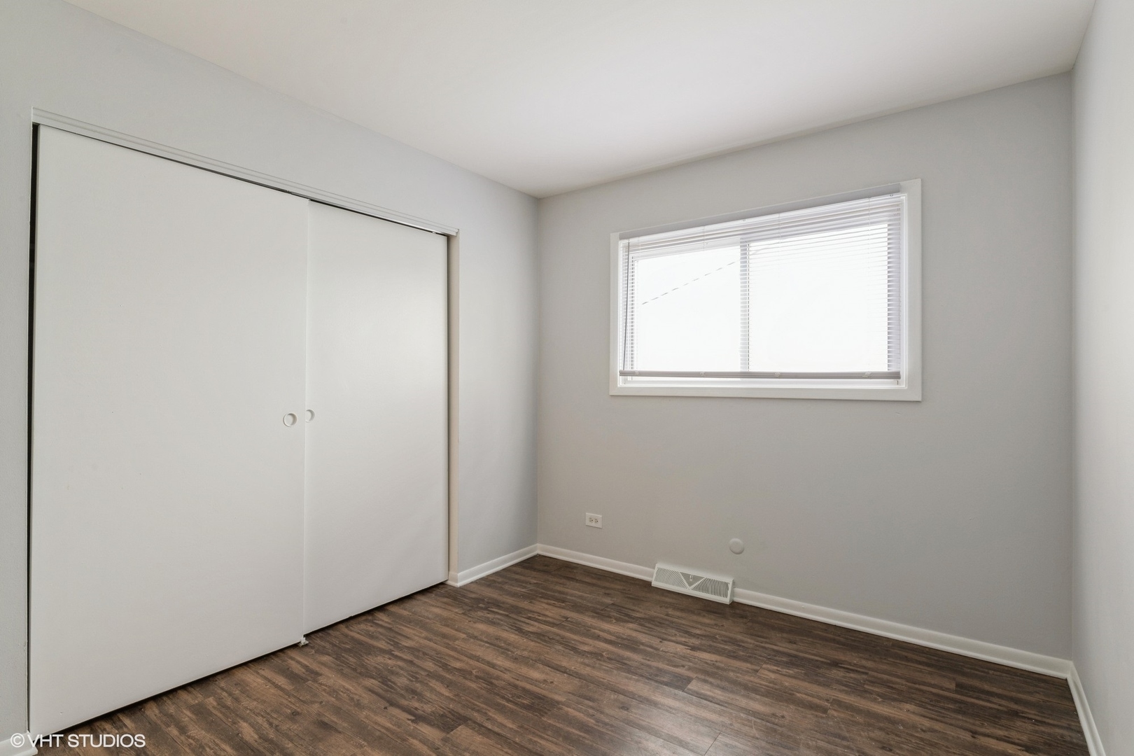 9349 Dee Road Des Plaines, IL 60016 - Photo 14 of 22 an empty room with wooden floor and windows